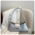 Detailed shot of silver half-moon shoulder bag with double knotted straps and metal buckle - Silver