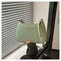 Detail of mint green crescent bag with adjustable strap and golden fashion text - Green