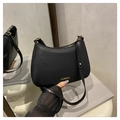 Detail of black PU leather half-moon shoulder bag with golden FASHION text and hardware - Black