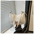 Detailed macro view of white crocodile pattern leather on a hobo shoulder bag - White