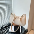 Chic off-white pebble leather shoulder bag with gold metal bow and slim strap - White