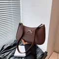 Deep brown pebble leather baguette bag with a golden bow buckle in a vintage style - Coffee