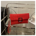 Red leopard print envelope clutch featuring a classic square buckle and wristlet strap - Red