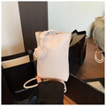 Close-up of cream white lychee texture leather mini crossbody bag with knot detail - White
