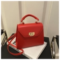 Classic red leather trapezoid handbag with gold metal clasp and top handle for women - Red
