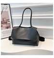 Minimalist black matte rectangular shoulder bag with thin straps on a white podium - Black