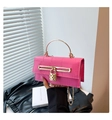 Close-up of pink faux crocodile leather bag with gold heart lock and metal handle - Rose Red