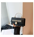 Detail of black faux crocodile skin bag with golden heart lock and metal handle - Black