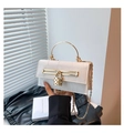 Detail of white crocodile texture bag featuring a unique heart-shaped gold padlock and handle - White