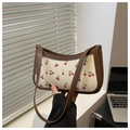Chic cherry print underarm bag in cream and brown leather with curved crescent shape - Brown