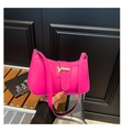 Detailed close-up of hot pink underarm bag with gold buckle and smooth leather texture - Rose Red