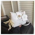 Detail van witte imitatielederen crossbodytas met houtnerf gesp en een zijden sjaal - Wit