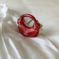 Detail of red ripple metal dumpling bag with gold chain and unique pleated texture - Red