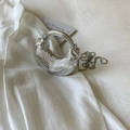 Detail of silver half-moon evening bag with metallic pleated texture and chain strap - Silver