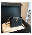 Structured black woven handbag with gold V-shaped buckle and adjustable shoulder strap - Black
