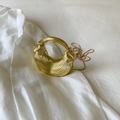 Detail of golden acrylic hobo bag featuring pleated texture and metal chain strap - Gold