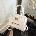 White faux leather crossbody motorcycle tote bag with top handle and metal buckle - White