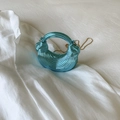 Close-up of bright blue metallic dumpling bag with pleated texture and gold chain strap - Blue
