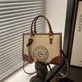 Retro canvas tote bag with brown leather trim and circular logo in beige and tan - Khaki with Brown