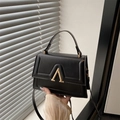Minimalist black square crossbody bag with gold A-shaped buckle and top handle - Black