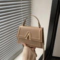 Minimalist beige crossbody bag for women with golden metal buckle and textured leather finish - Khaki
