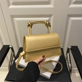 Metallic gold synthetic leather handbag with knotted handle and slim shoulder strap - Gold