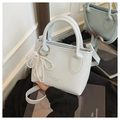 Detail of light blue lychee texture handbag with pearl lace bow and metal ring buckle - Blue With Charm
