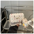 Close-up of white crossbody bag with cute teddy bear prints and plush rabbit charm - White With Pendant