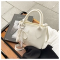 White lychee pattern mini bucket bag with pearl and lace bow pendant on a wooden bench - White With Pendant