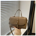 Detail of dark khaki crossbody bag featuring textured lychee grain leather and gold buckle - Khaki