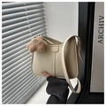 Detail of cream hobo shoulder bag featuring vertical stitching and a cute plush bear charm - White (With Star Charm)