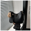 Detail of black faux leather baguette bag with FASHION label and brown teddy bear charm - Black (With Star Charm)