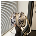 Minimalist white drawstring bucket bag with black butterfly print and gold hardware - Black Butterfly Pendant