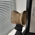 Khaki hobo shoulder bag with moon shape and adjustable strap under cinematic light - Khaki