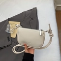 Minimalist beige pebble leather crescent shoulder bag with knotted strap and zip closure - Off-white
