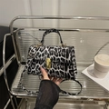 Elegant black and white leopard print crossbody bag with gold hardware and top handle - Leopard Print Black