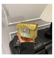 Detail of gold crocodile embossed mini square bag with silver metal push-lock and chain - Gold