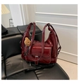 Close-up of a burgundy tote bag with white contrast stitching and a plush bear charm - Red with Pendant
