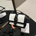 Elegant geometric embossed handbag with black and white contrast and gold metal clasp - Black and White