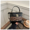 Detail of leopard print stitching and golden double zipper on a retro box handbag - Black