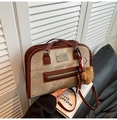 Brown leather and canvas tote bag with bear charm and scarf in a lifestyle setting - With Pendant / Red