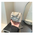 Close-up of cream lychee leather mini bag with pearl handle and bow decoration - Khaki