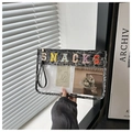 Close-up of leopard print transparent PVC toiletry bag with colorful SNACKS letter embroidery - Leopard Print Black