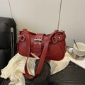 Chic red faux leather underarm bag featuring silver rivets and a stylish belt buckle - Red