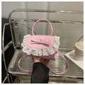 Dettaglio della borsa rosa con bordo in pizzo bianco e fiocco decorativo applicato - Rosa