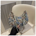 Detailansicht der Blumenstickerei und des Metalllogos auf der elfenbeinfarbenen Tasche - Blau
