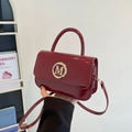 Retro deep red glossy patent leather handbag with gold M logo buckle and top handle - Red