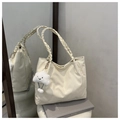 Detail of cream quilted tote bag with woven handle and plush cloud charm on books - Off-White (With Pendant)