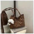 Detailed texture of brown embossed tote bag with braided handles and cloud charm - Brown (With Pendant)