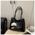 Detail of black quilted tote bag with bear embossing and woven straps on a textile base - Black With Pendant